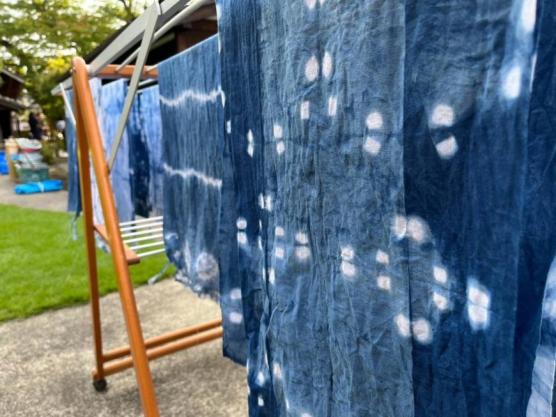 色々な藍染めされた布が外に干してある写真