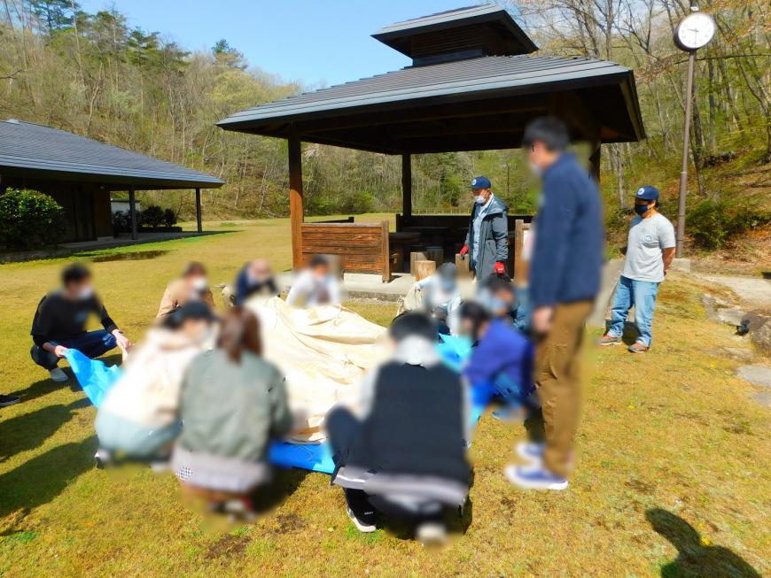 参加者達でDAYキャンプでテント張りをする様子の写真