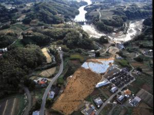 山や道路などが見える中に茶色い土の部分が見られる和台遺跡全景を上空から撮影した写真