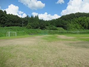 所々草が生えた広いグラウンドの端にサッカーゴールが置かれている下川崎地区運動場の写真