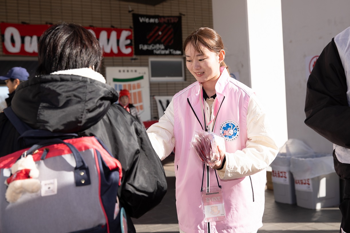 試合の観戦者へチラシを配る隊員