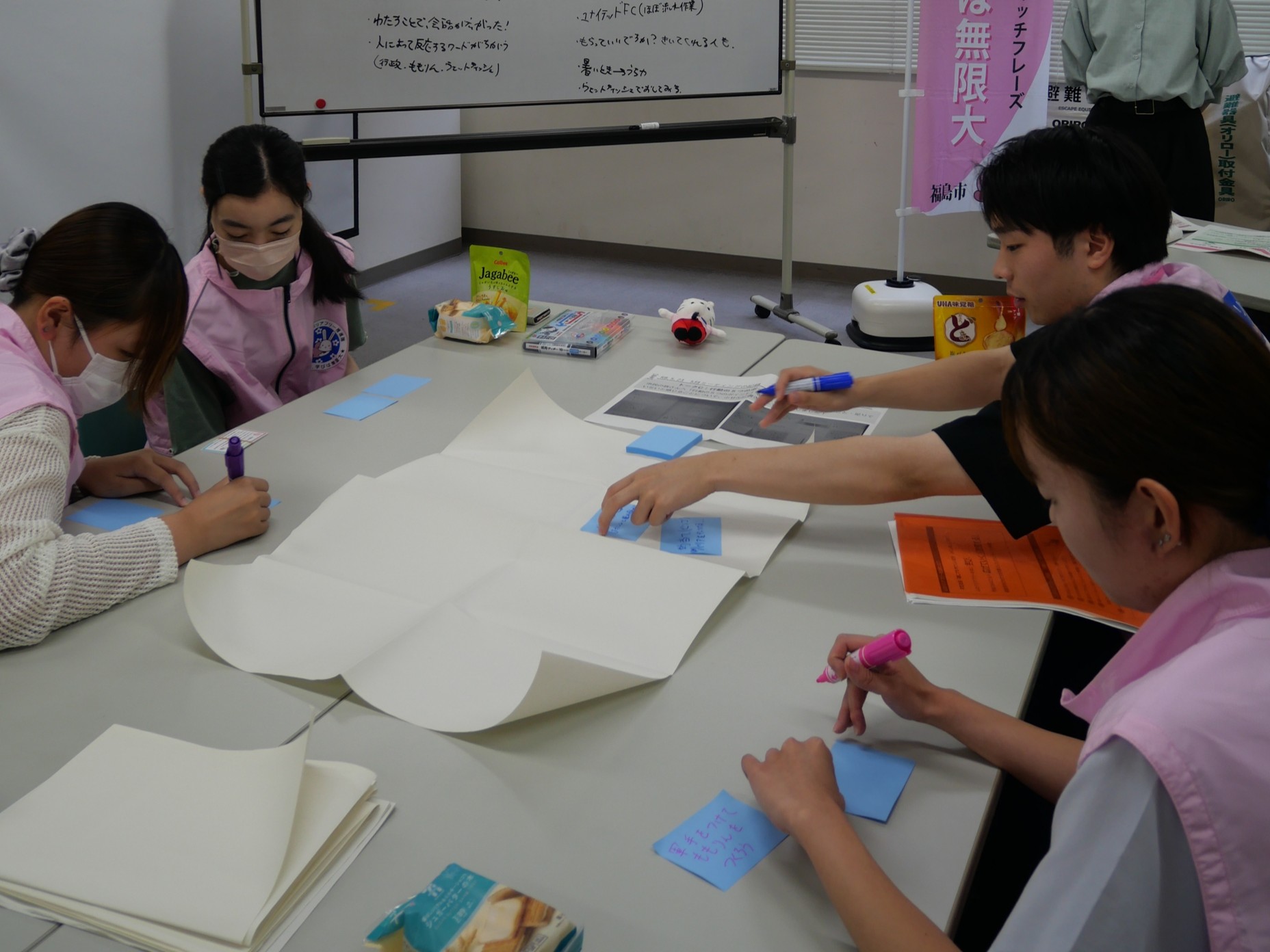 話し合いながらふせんにアイデアを書き出す隊員
