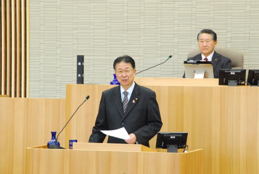 資料を左手で持ち話をしている高木克尚議員の写真
