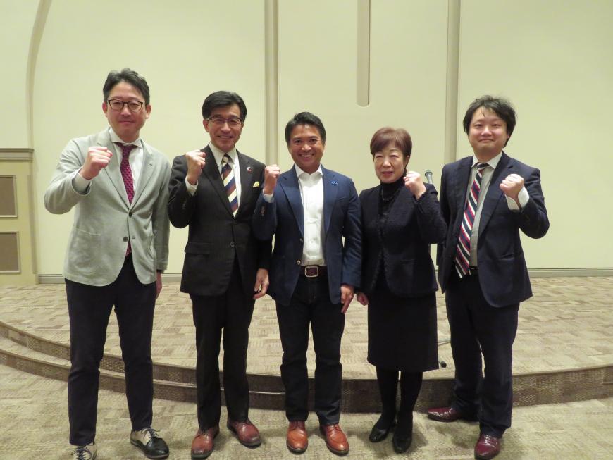 市長を含めて男性4名、女性1名が横一列に並び、ガッツポーズをしている写真