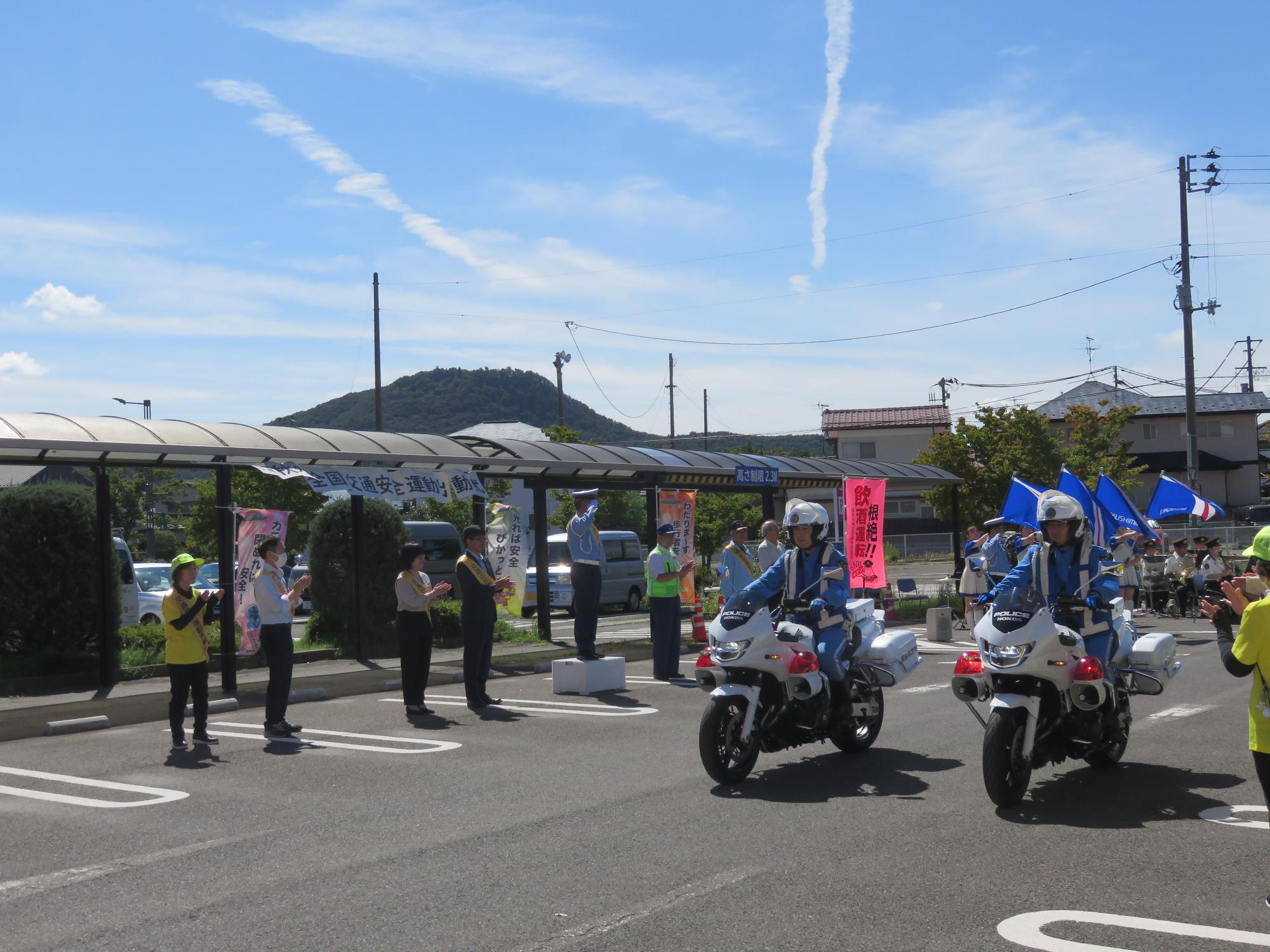 白バイとパトカーが街なかへ出動する様子
