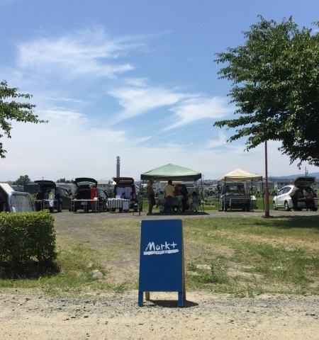 手前に看板が設置された「マルクト朝市」の写真