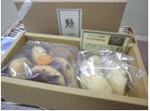 ベージュ色の箱に透明袋に入ったお菓子が並んだギフト詰め合わせの写真