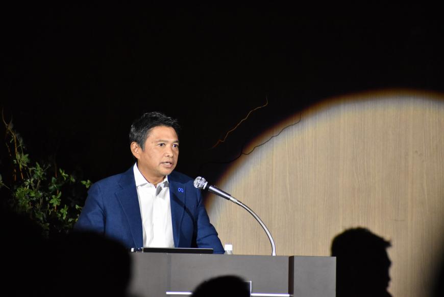 檀上に立つ味澤氏が講演を行っている様子の写真