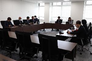 ロの字型に並べられた机に8人ほどが座り、それぞれタブレットの画面を見ている写真